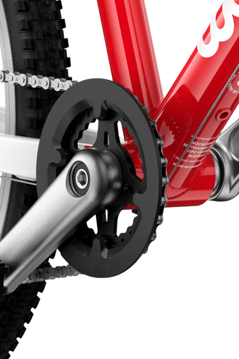 Detailed view of the cranks and pedals on the woom GO 4 children's bike