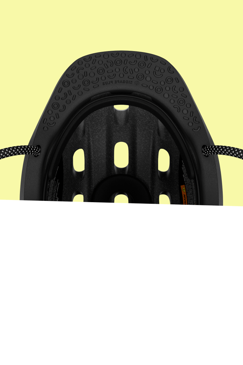 Inside view of a black woom READY kids helmet with padding and patterns, seen from below.