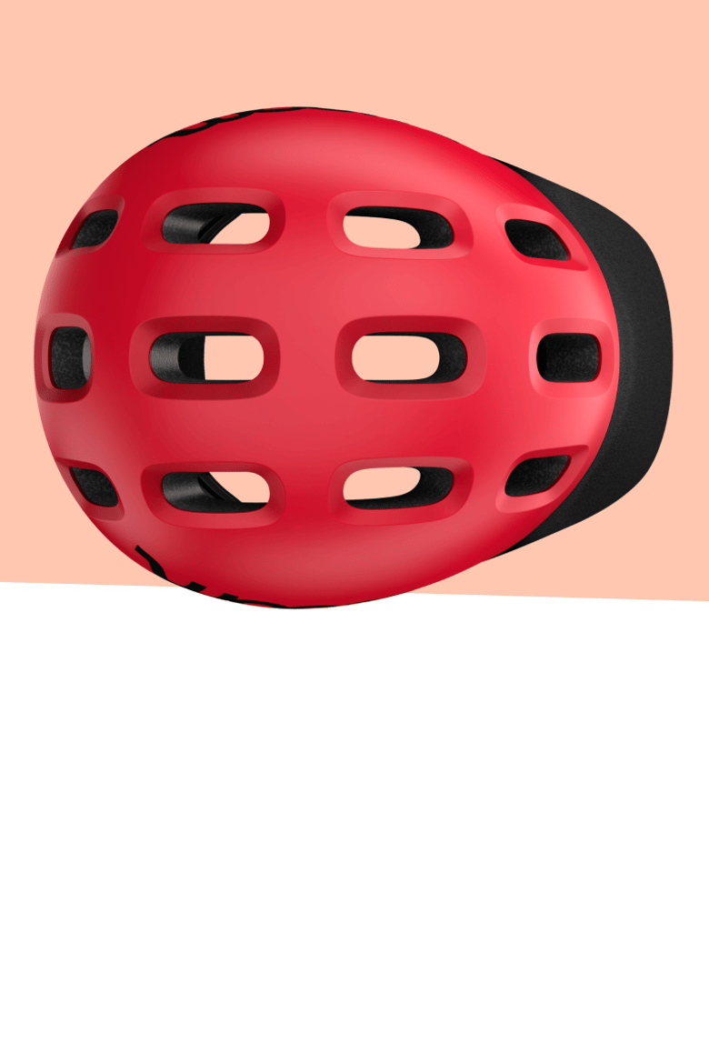 Red woom READY bike helmet with oval ventilation holes seen from above, against a light yellow background.