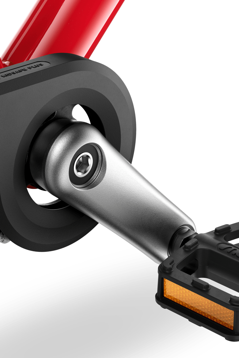 Detailed view of the cranks, pedals and chainguard on the woom GO 3 children's bike
