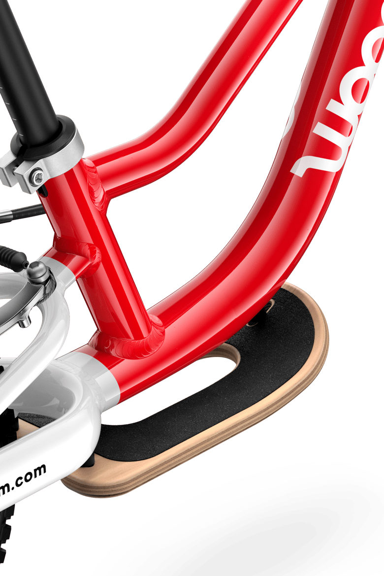 Detailed view of the wooden footrest that can be added to the woom GO 1 balance bike