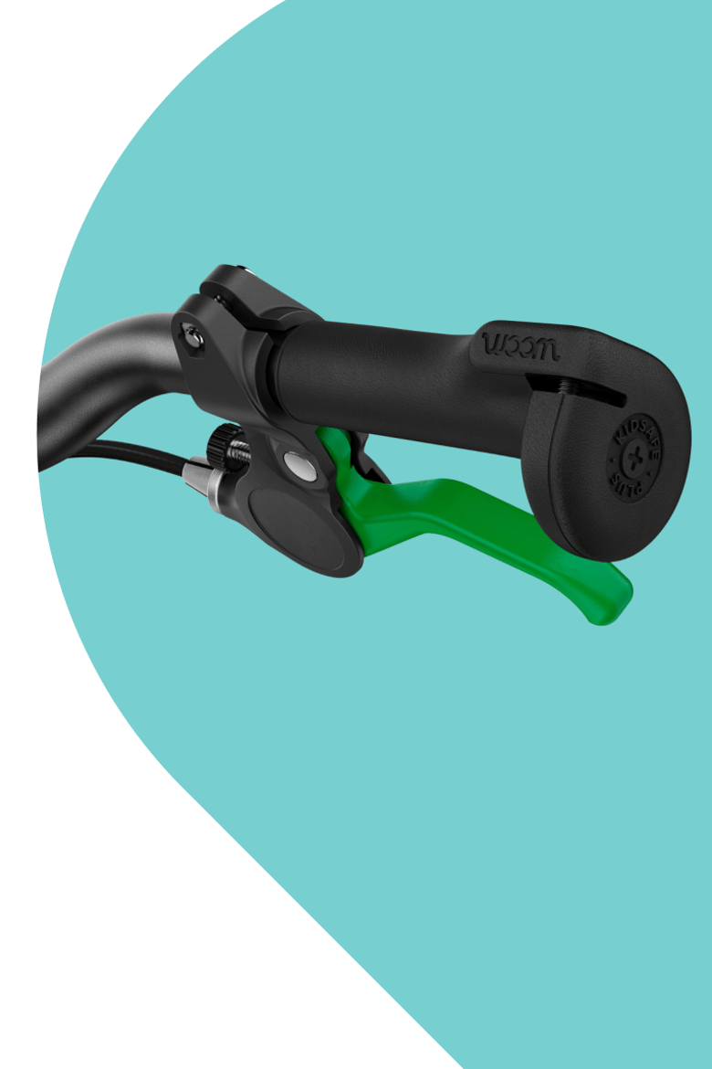 Close-up of black woom handlebar grip with a green brake lever.