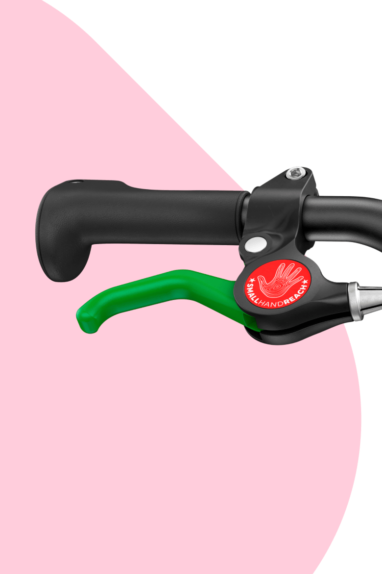 Close-up of the green lever for the rear brake on woom GO bikes