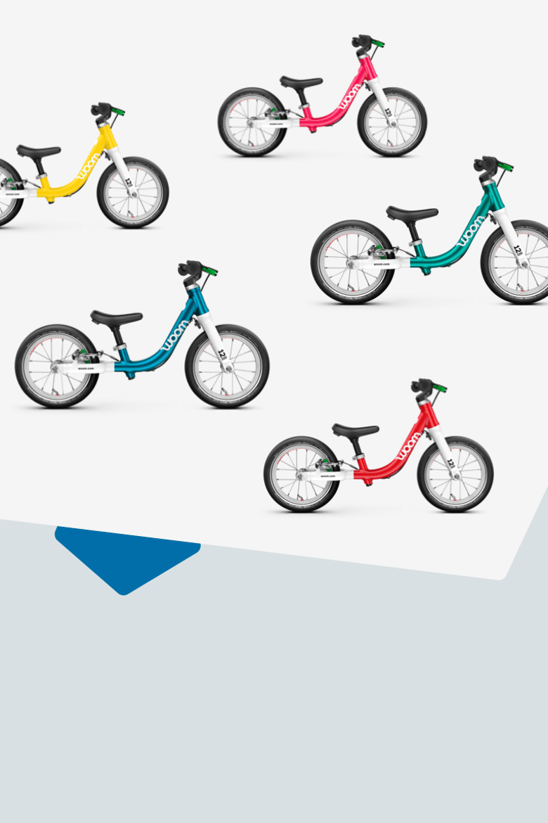 Sidobild av balanscyklarna woom GO 1 i fem färger woom red, metallic turquoise, metallic blue, hot pink och vibrant yellow