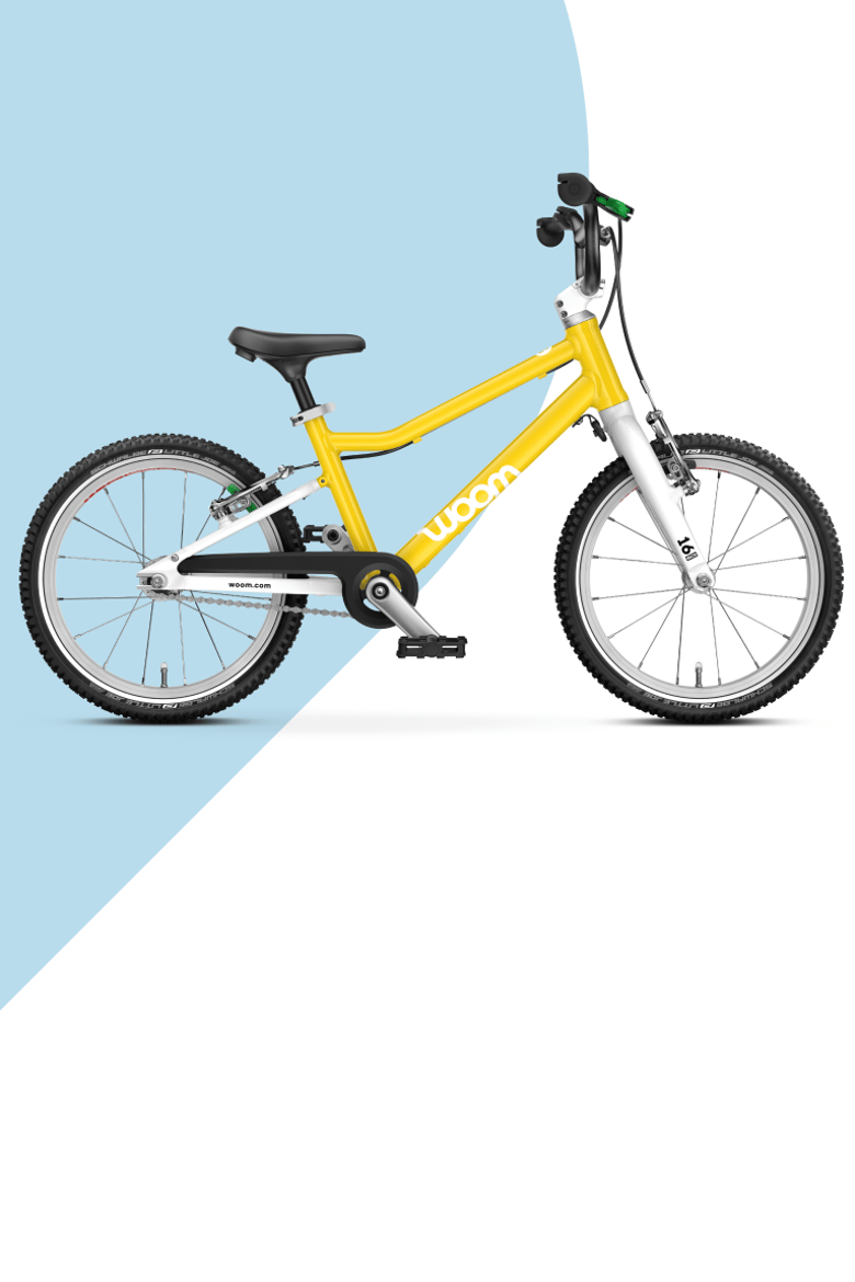 A red woom GO 3 16" bike for kids aged between 4 to 6 years, viewed from the side