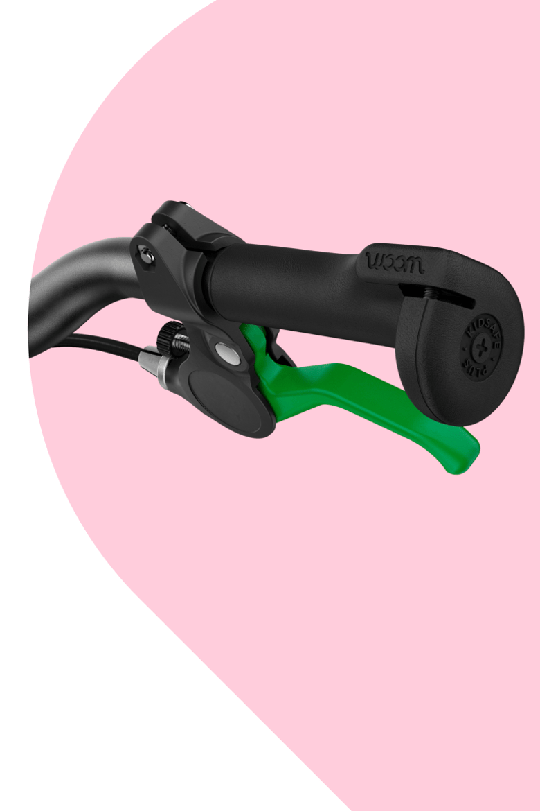 Close-up of the protective, oversize handlebar grip ends and green brake lever on woom GO bikes