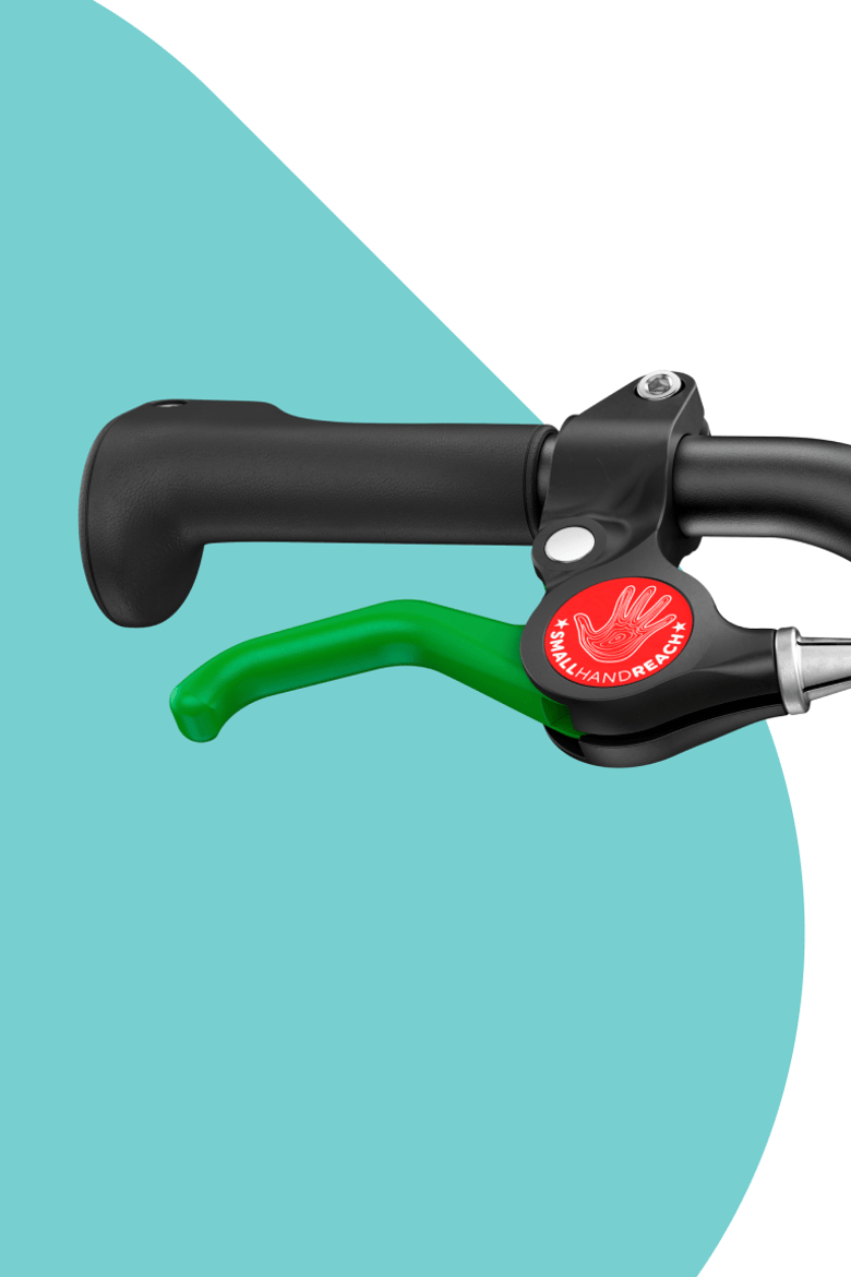 Close-up of black woom handlebar grip with a green brake lever.