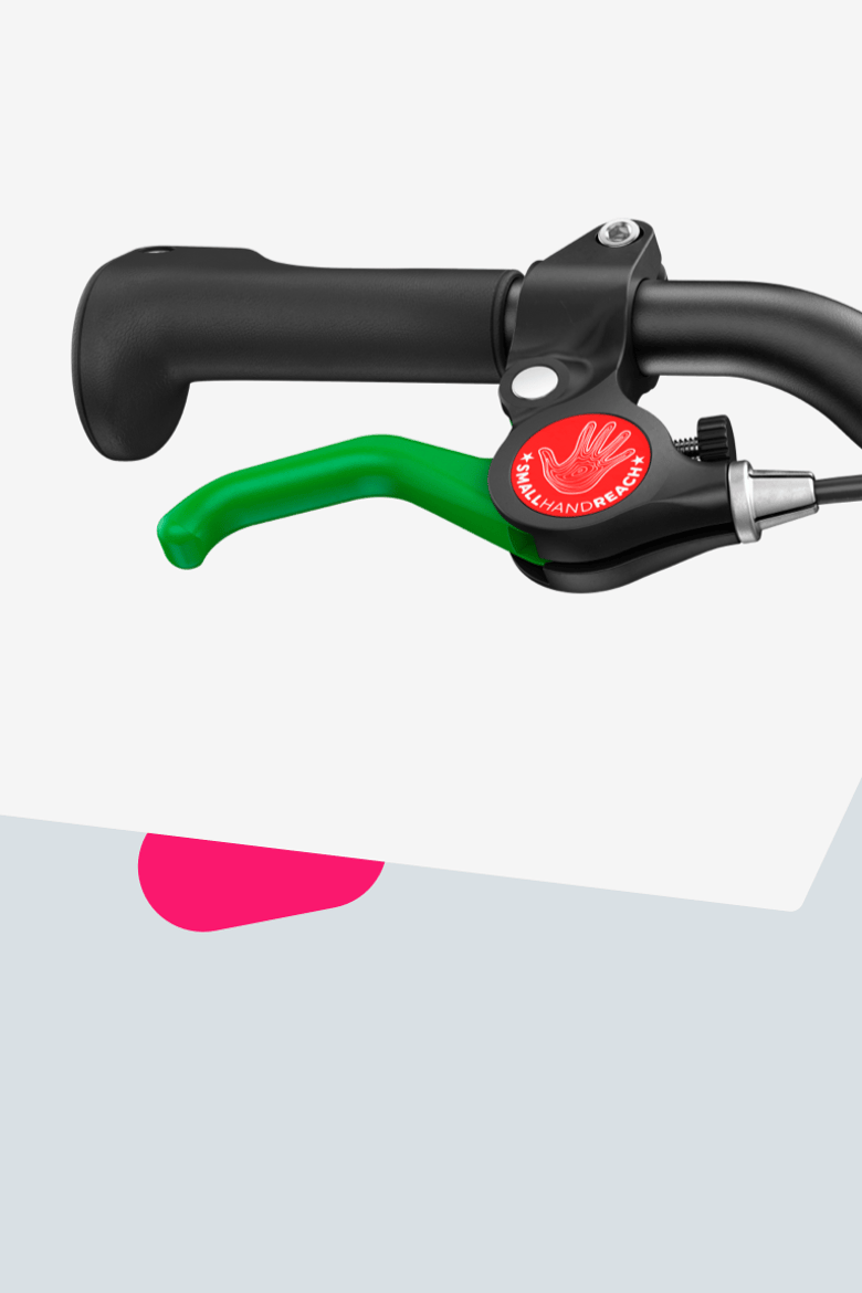 Close-up of the green lever for the rear brake on a woom GO balance bike