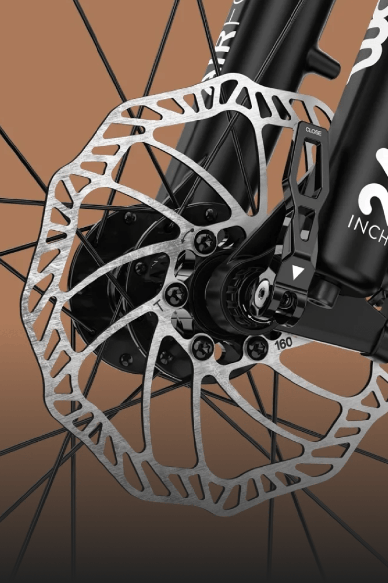Detailed view of the powerful disc brakes on the front wheel of a woom OFF 5 kids' mountain bike