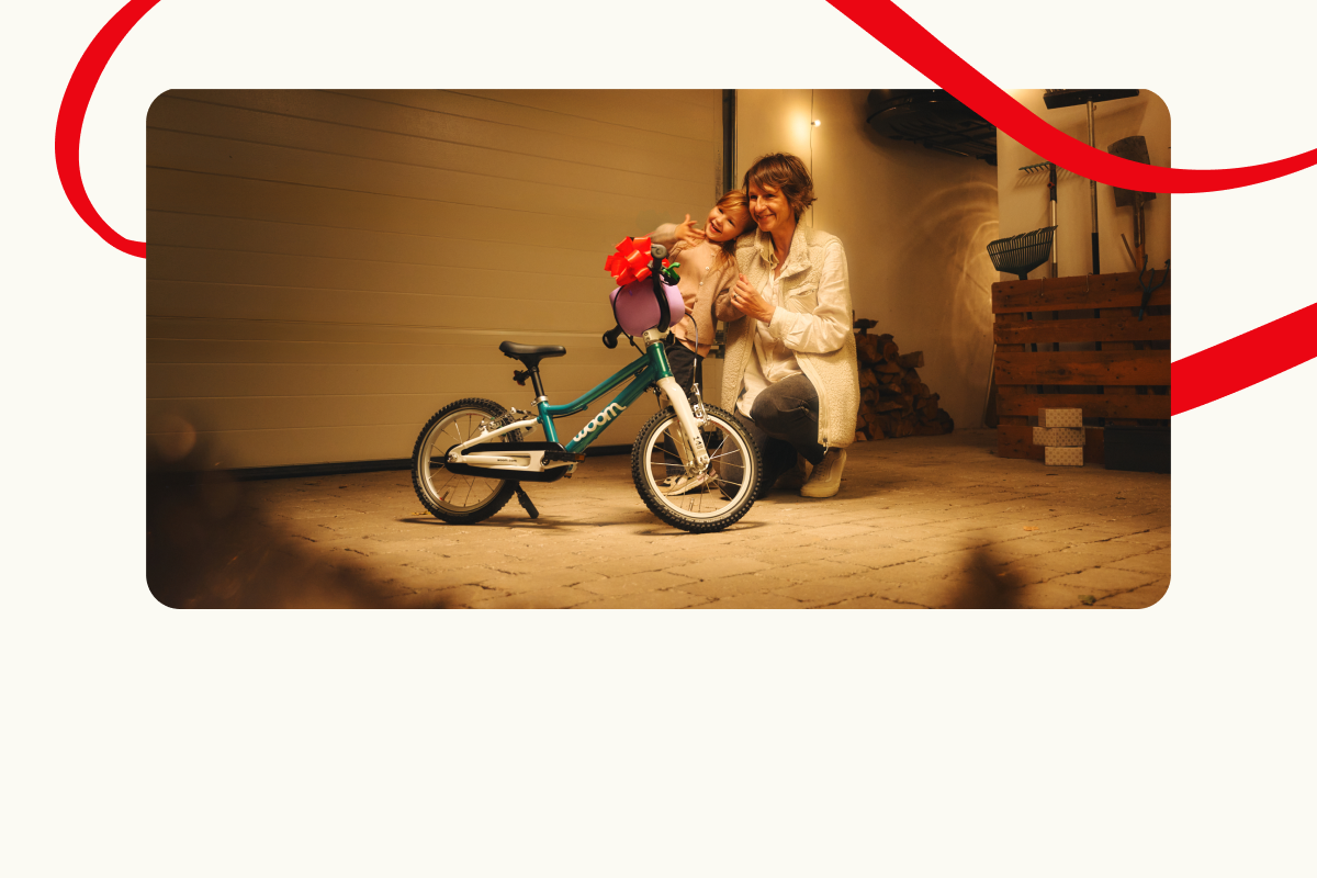 Adult kneeling next to a child and a woom GO in front of a garage. Decorative red lines frame the scene.