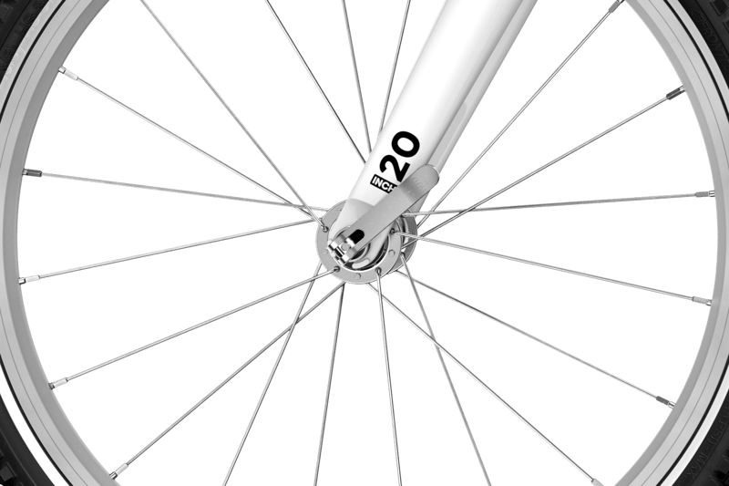 Detaljerad vy av framhjulets snabbkopplingsaxel på barncykeln woom GO 4 på 20 tum