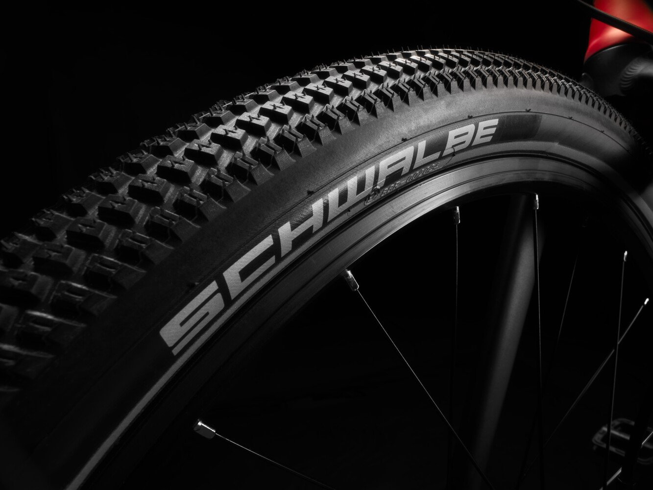 Close-up of a black bicycle tire on the woom EXPLORE children's bike with white Schwalbe branding on the sidewall.