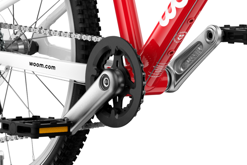 Detailed view of the cranks and pedals on the woom GO 4 children's bike