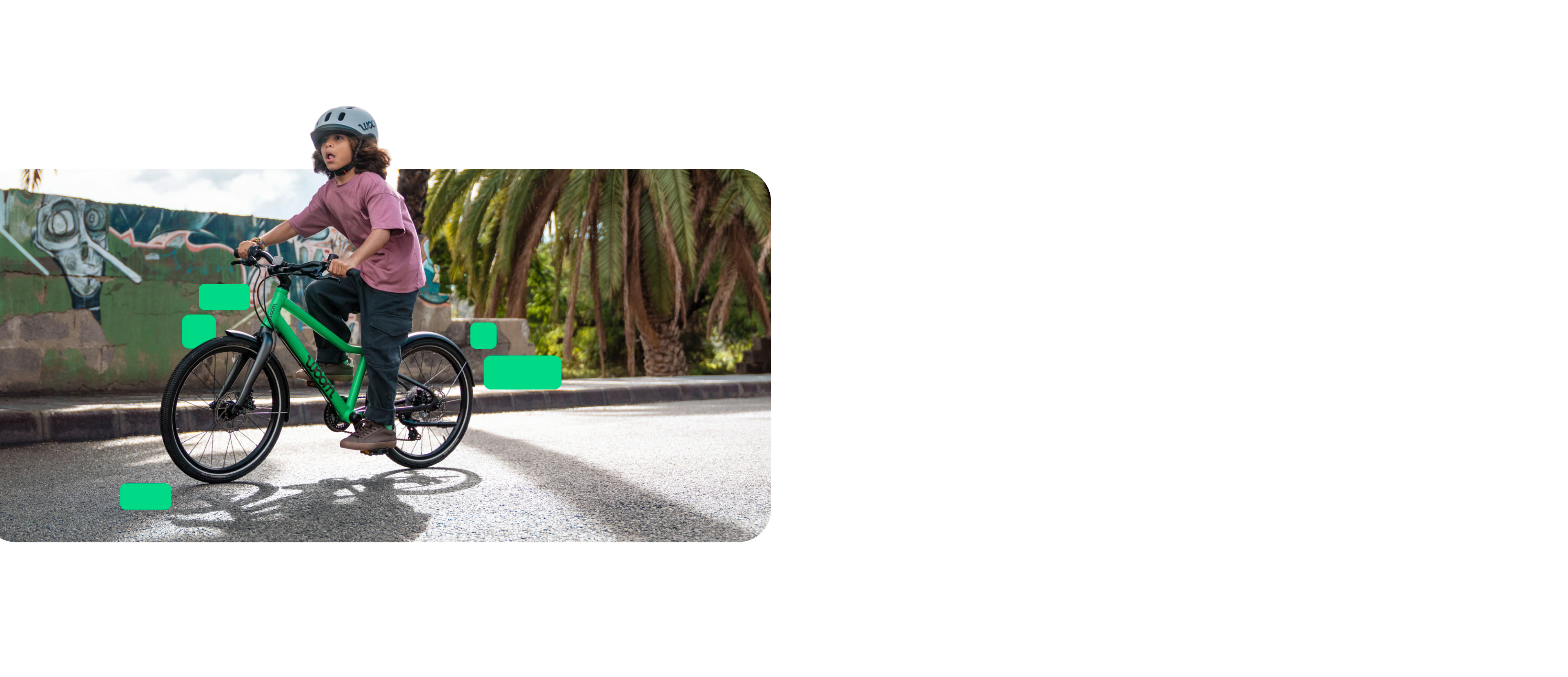 A person wearing a READY helmet rides a jungle green EXPLORE bicycle past a graffiti wall and palm trees.