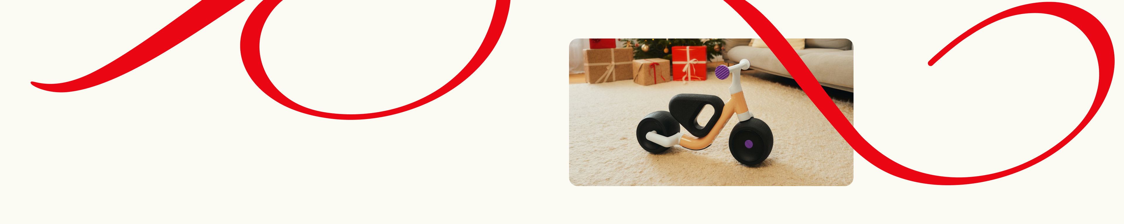 woom WOW indoors on a rug, with gift boxes and a couch in the background. Decorative red lines frame the scene.