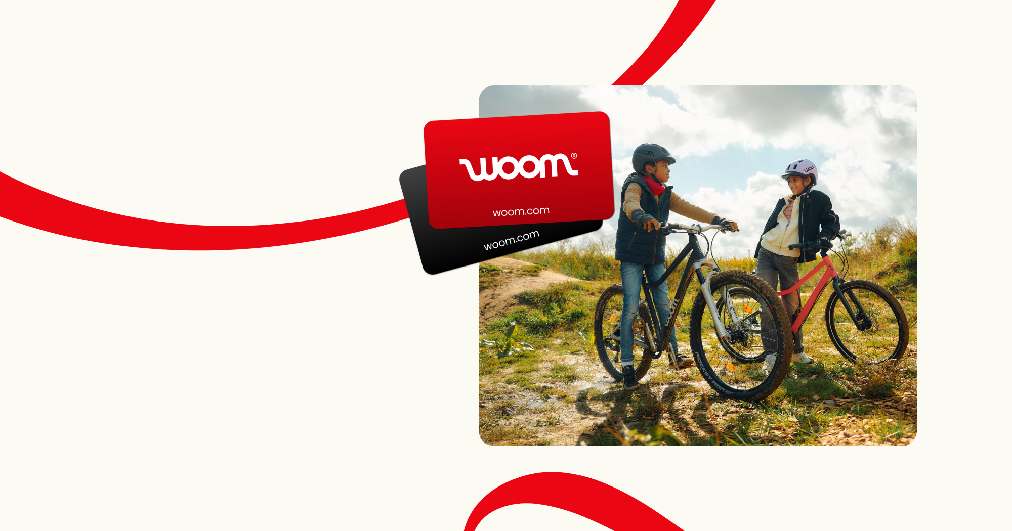 An image featuring two woom gift cards superimposed on a photo of two kids in a hilly outdoor setting. One is on a woom EXPLORE and the other is on a woom OFF, and they are chatting with each other while wearing woom READY Helmets. This is overlaid on a cream-colored background with red ribbons.