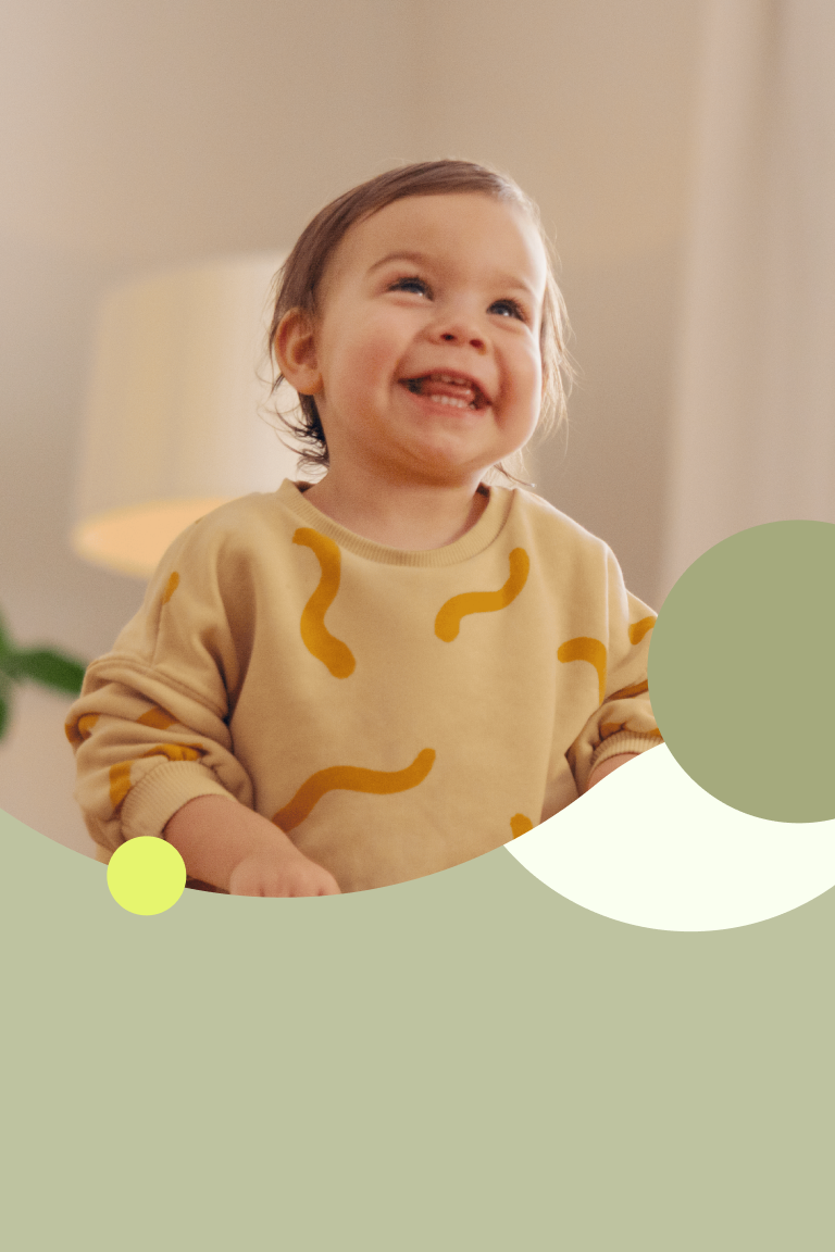 Toddler with a big grin.