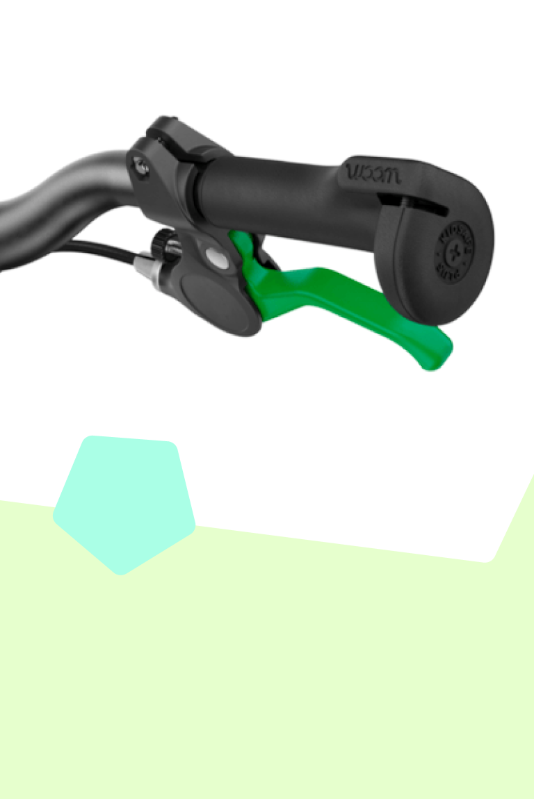 Close-up of the protective, oversize handlebar grip ends and green brake lever on woom GO bikes