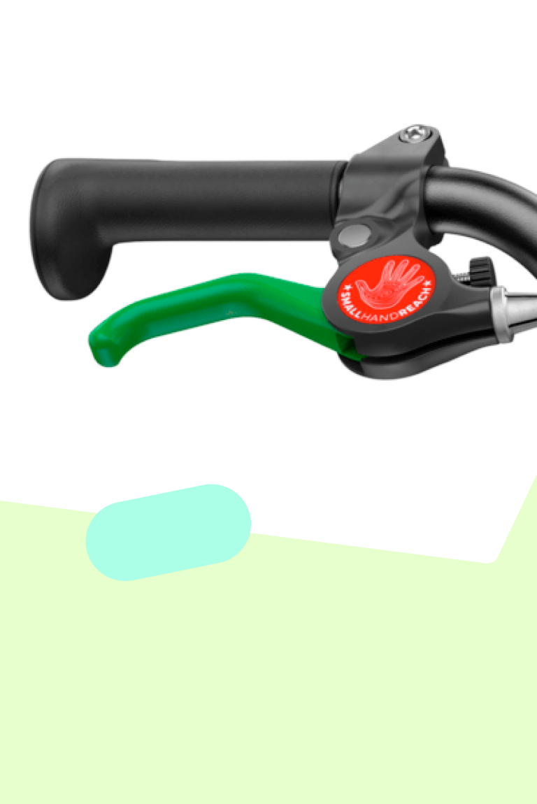 Close-up of the green lever for the rear brake on woom GO bikes