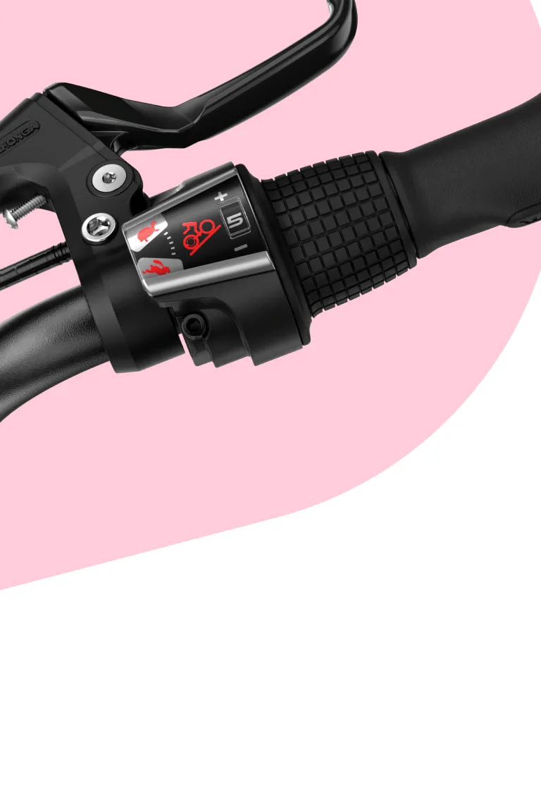 Close-up of the twist shifter on the woom GO 4, showing a hare for faster gears and a tortoise for slower gears