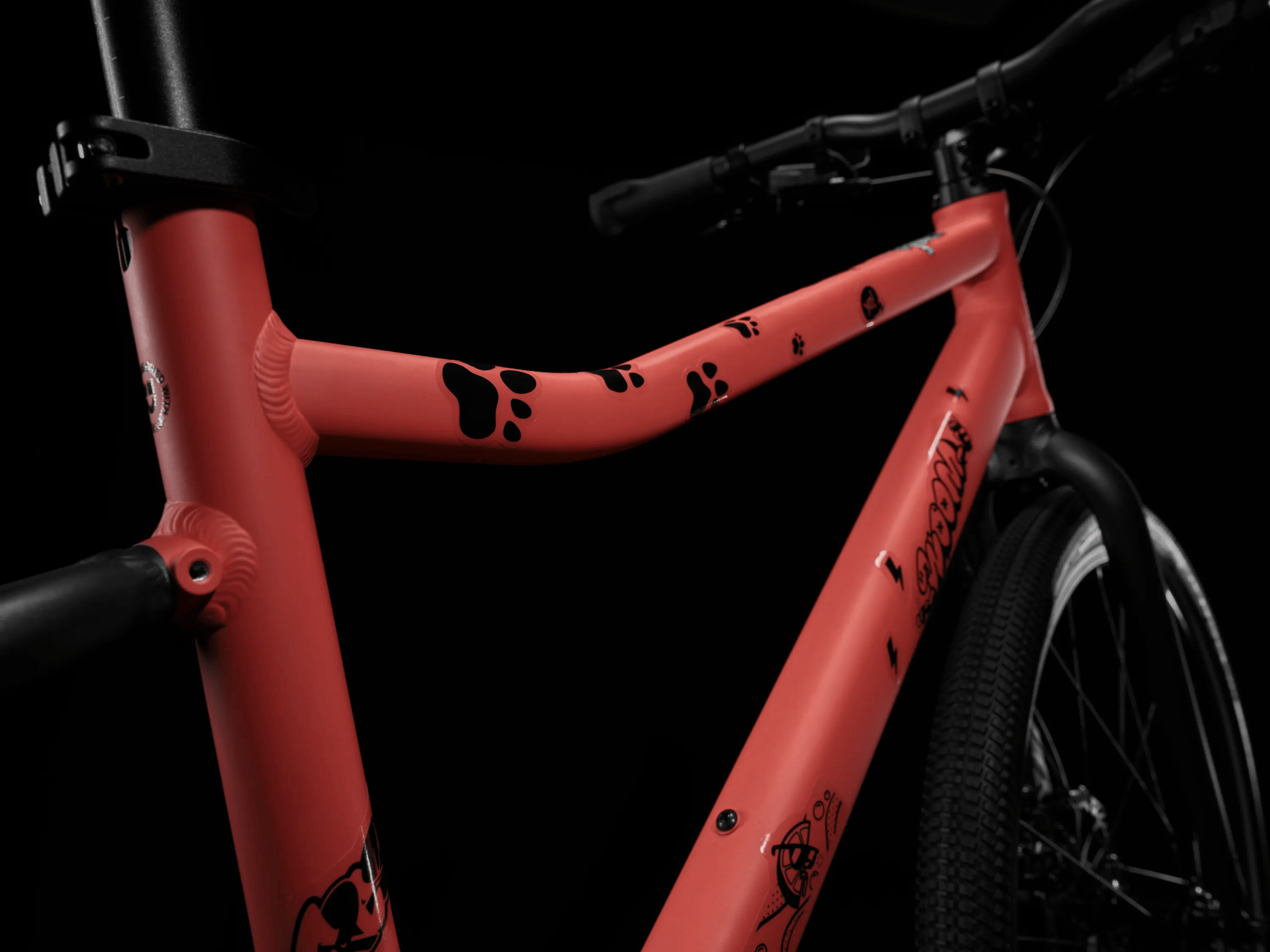 A red woom EXPLORE frame with a selection of black-transparent stickers on it.