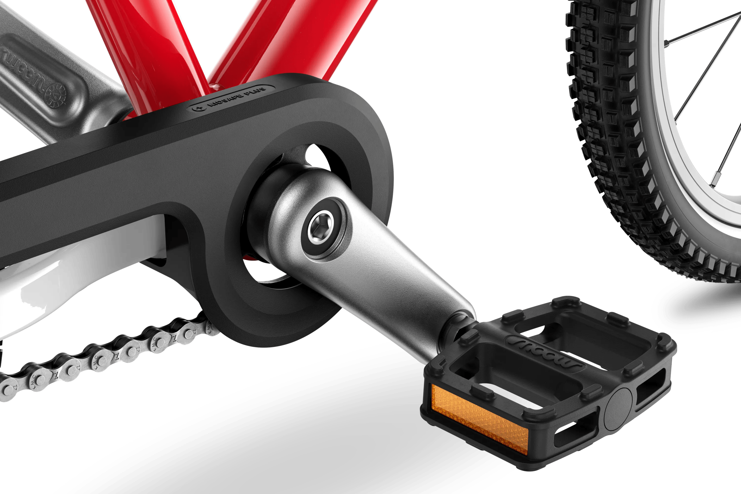 Detaljerad vy av vevparti, pedaler och kedjelåda på barncykeln woom GO 3