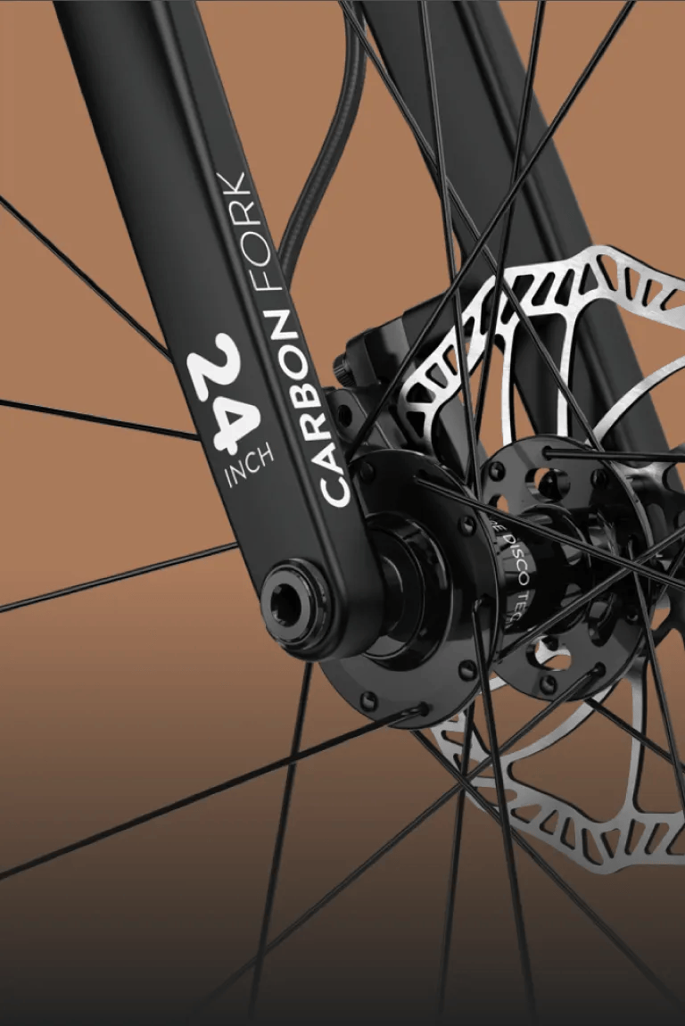 Detailed view of the black carbon fork on the woom OFF kids' mountain bike with 24″ wheels