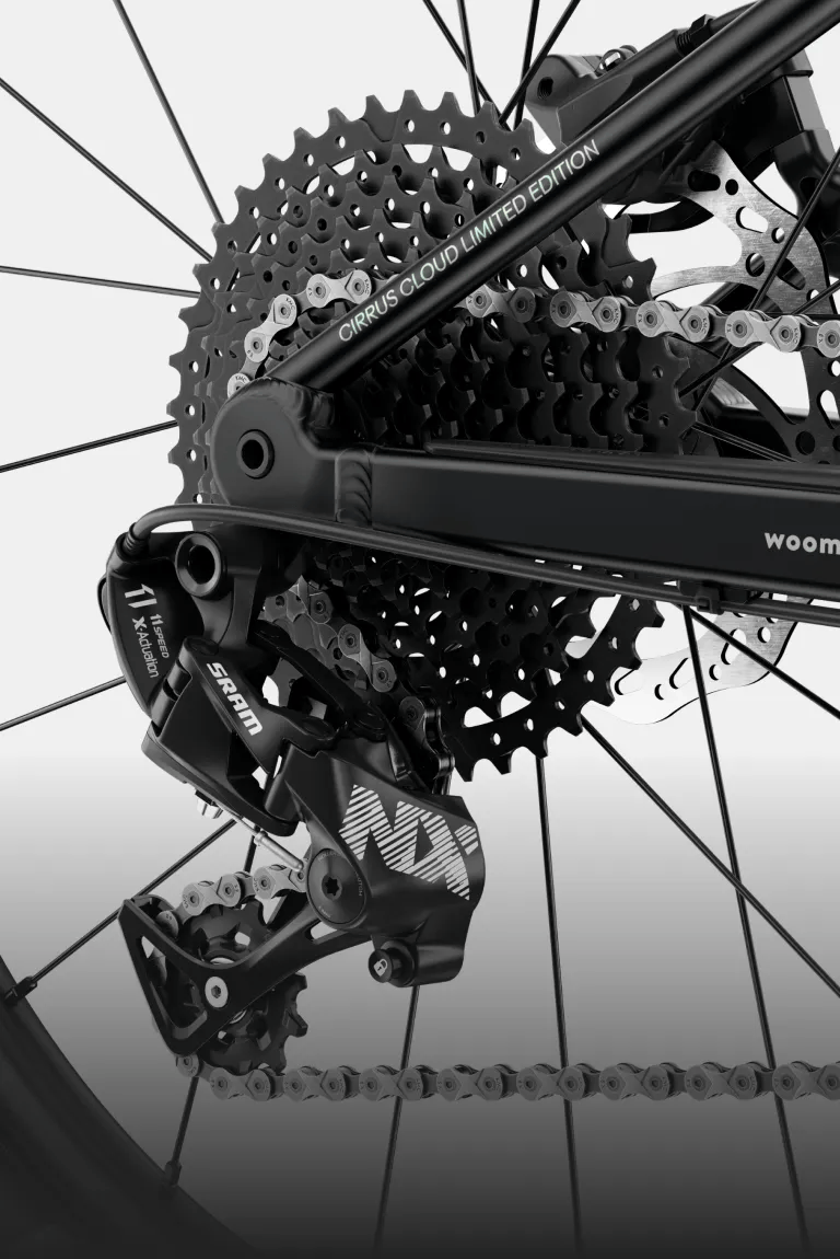 Detailed view of the SRAM drivetrain and chain on the rear wheel of the woom UP cirrus cloud.